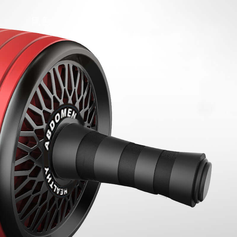 Home fitness abs wheel close-up showcasing the ergonomic handle and wheel design in red color.